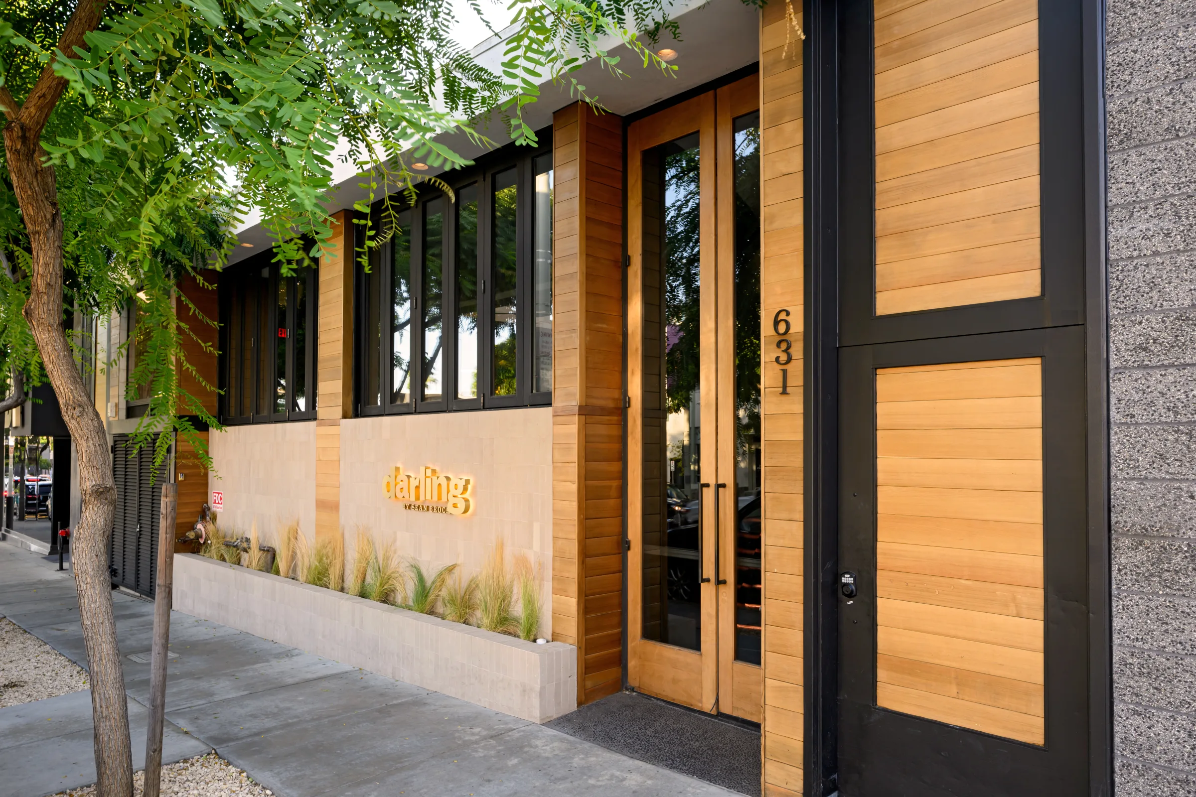 The darling by Sean Brock entrance at 631 Robertson, cedar doors under the trees